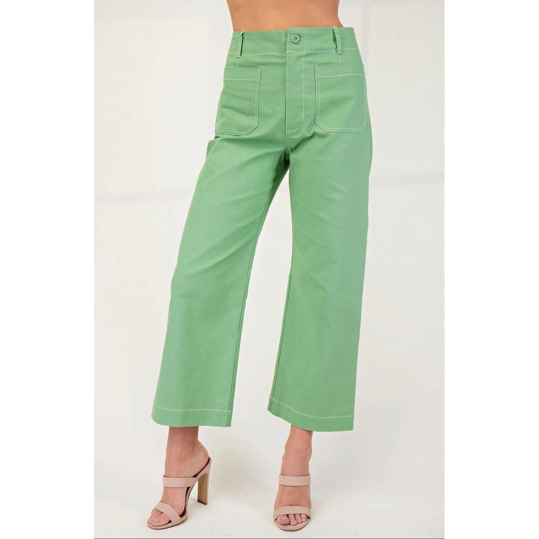 Green pants worn by a person on a white background