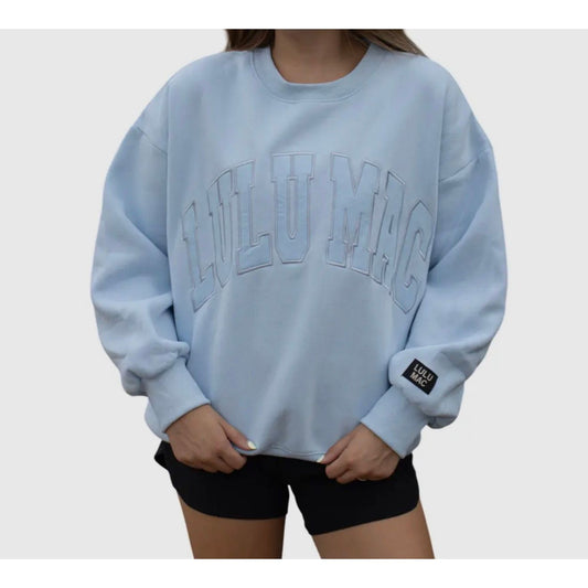 Light blue sweatshirt with 'LULU MAC' branding on a plain background