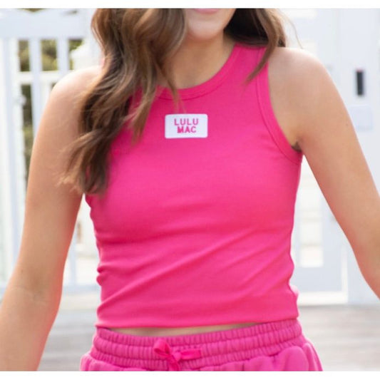 Person wearing a pink 'LULU MAC' tank top and shorts.