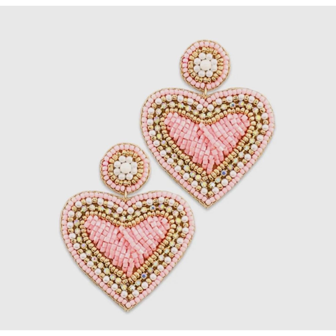 Heart-shaped beaded earrings on a light gray background