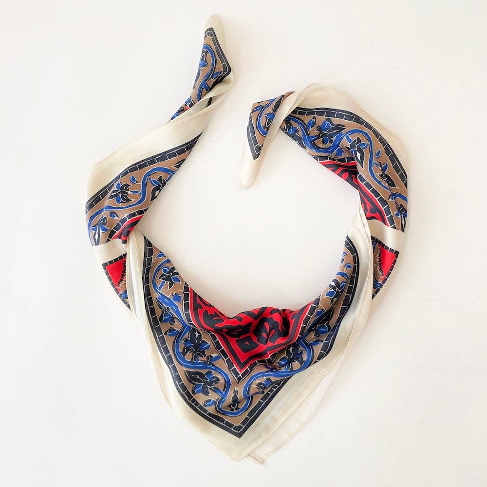 Annie Ks Boutique Alice square scarf featuring the geometric Burke Block pattern in red, blue, and cream soft fabric.