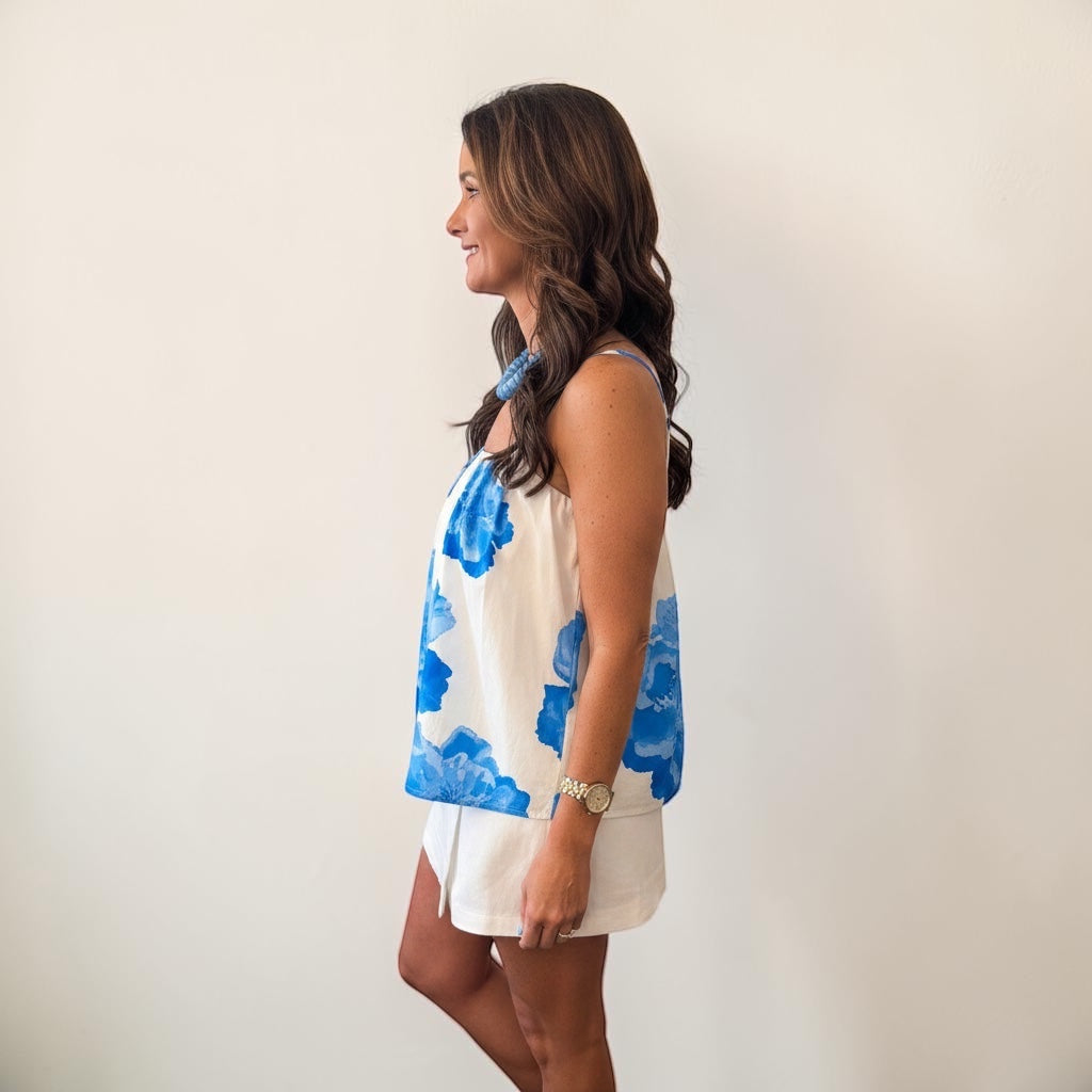 Annie Ks Boutique Americana Bloom Top in ivory and blue floral cotton with adjustable tie shoulders on a model