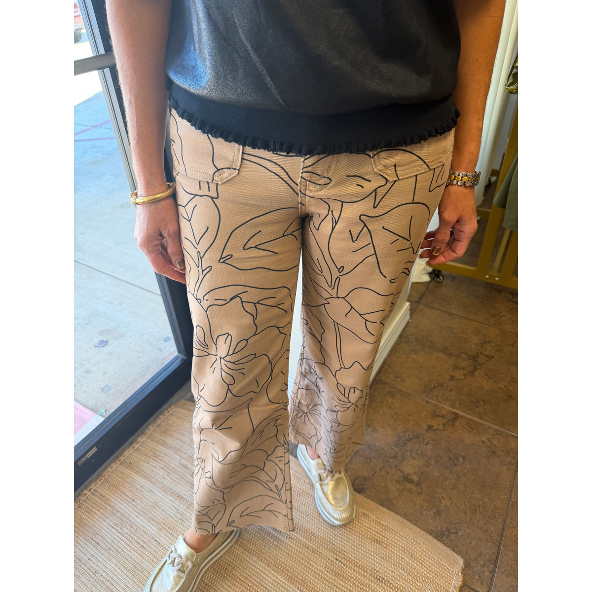 Annie Ks Boutique high-rise wide-leg jeans in beige with a black floral line art print and a cropped raw hem