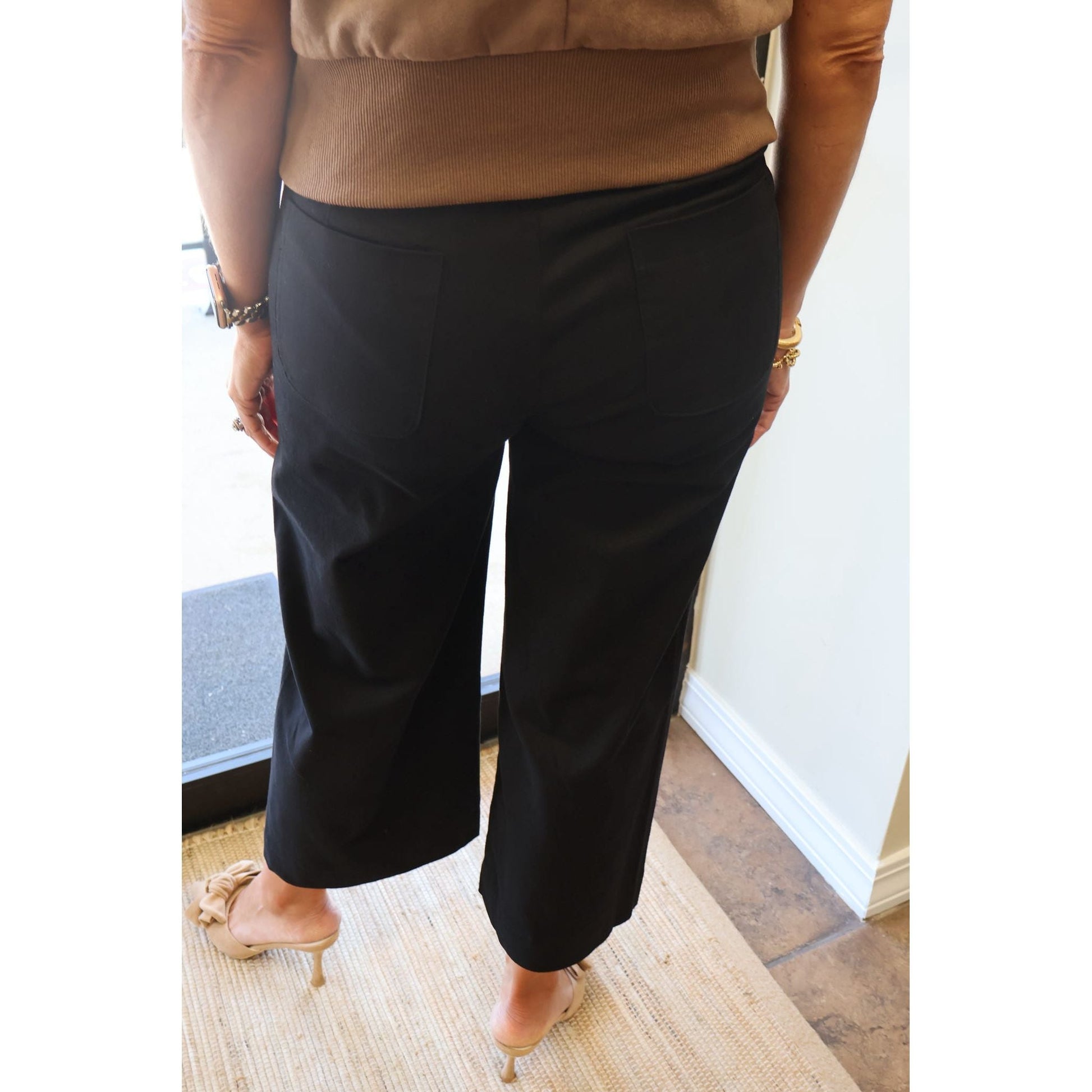 Annie Ks Boutique black cropped wide-leg pants with back pockets worn with a brown top and beige heeled mules