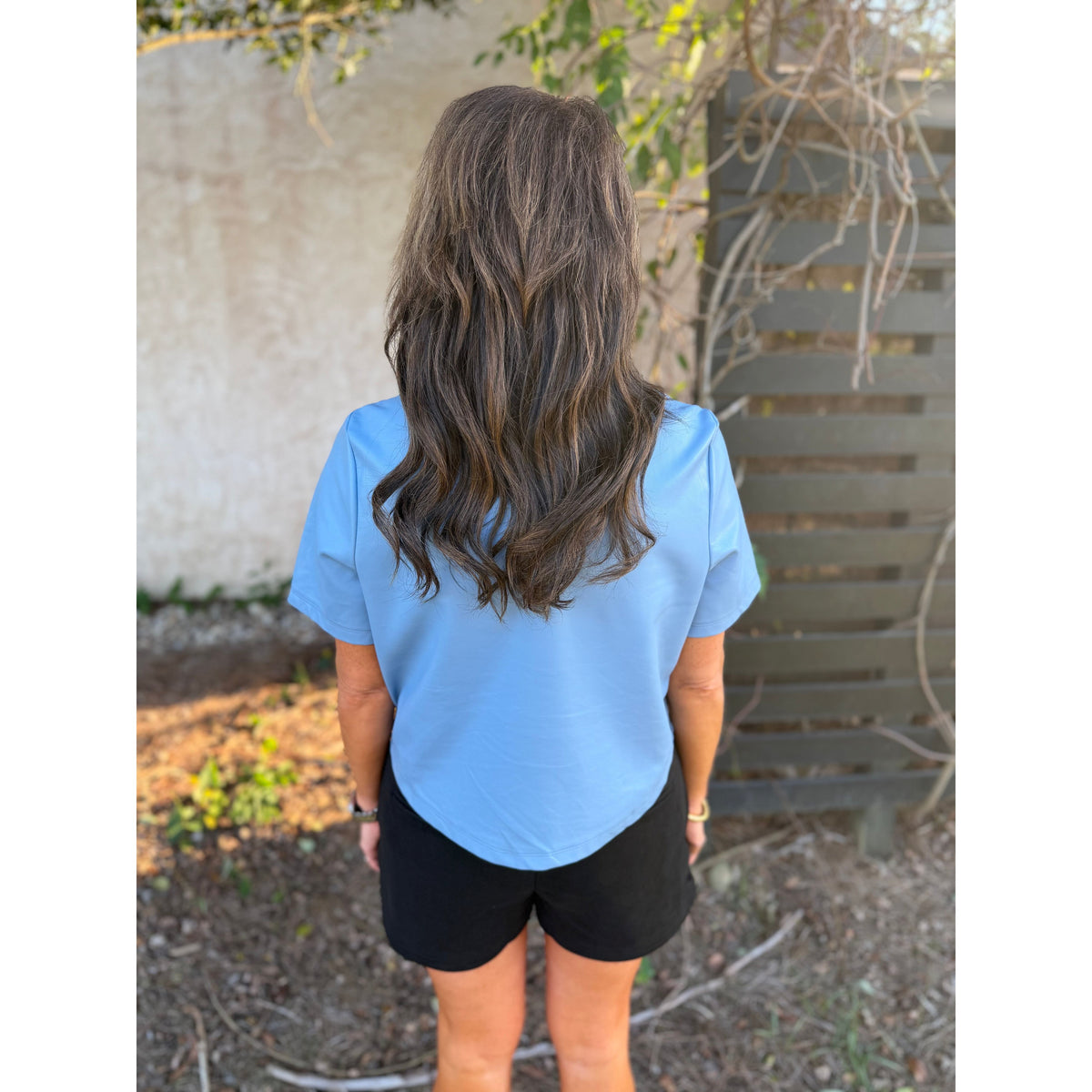 Annie Ks Boutique black faux suede shorts with a relaxed fit and side pockets worn with a light blue top