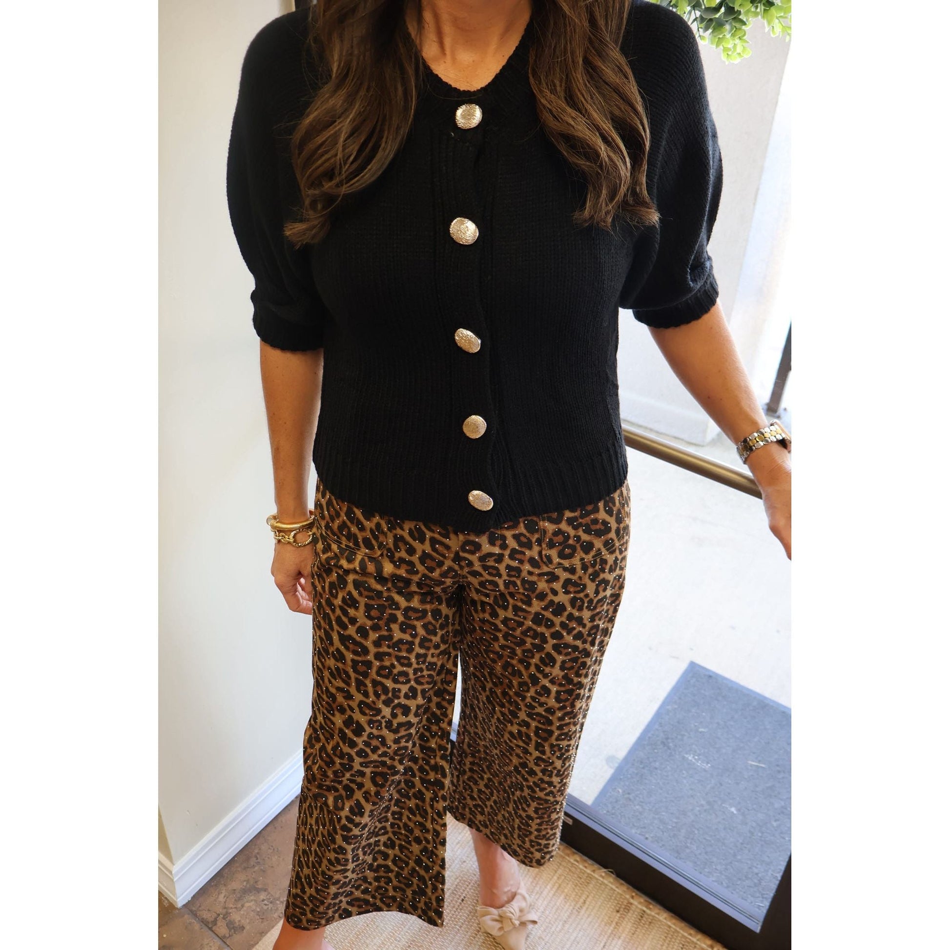 Annie Ks Boutique black knit cardigan with puff sleeves and silver buttons paired with leopard print cropped pants