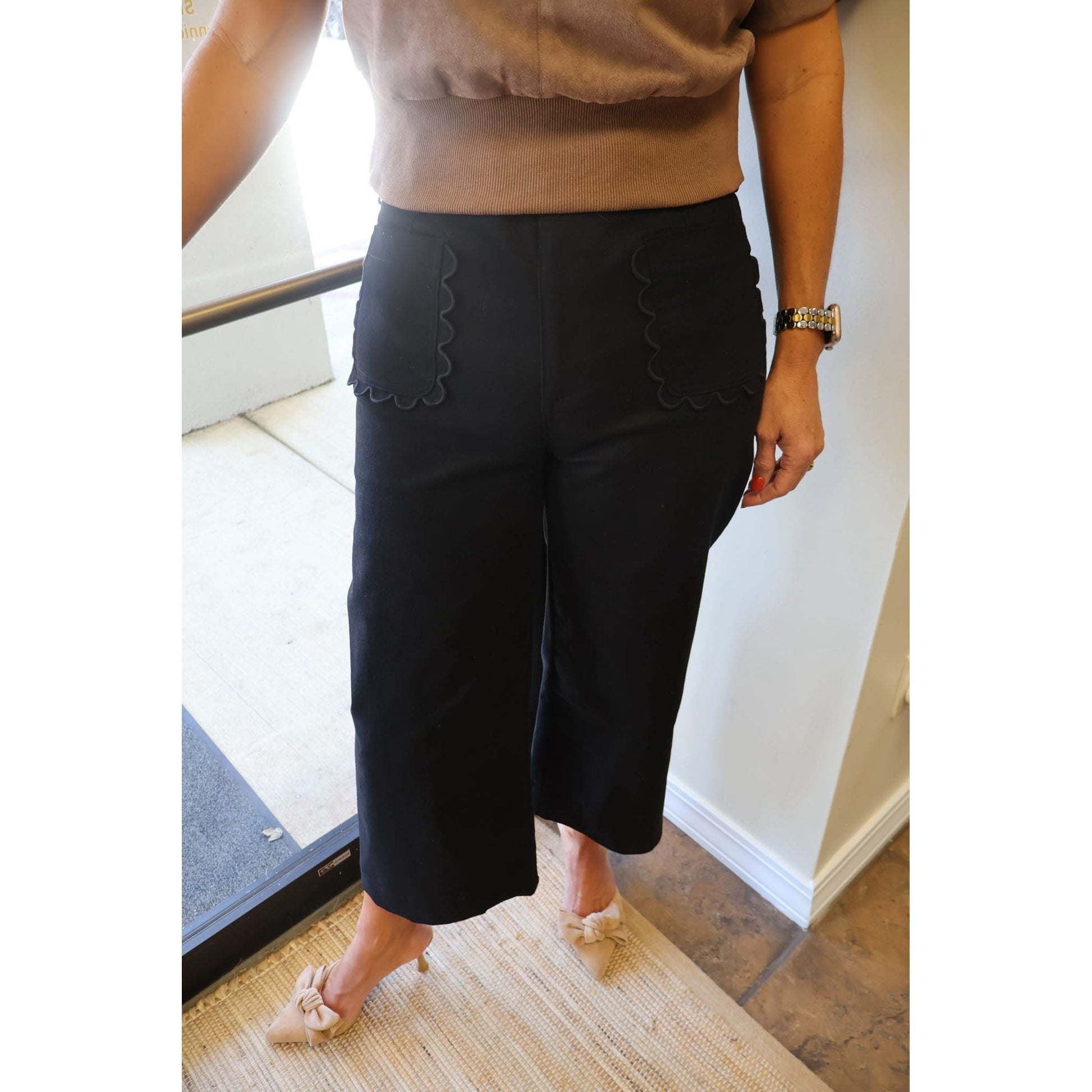 Annie Ks Boutique black cropped wide-leg pants featuring signature scalloped pocket details and a cotton-stretch fit.