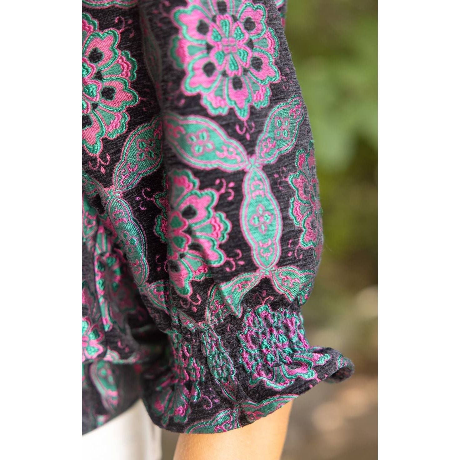 Annie Ks Boutique black velvet jacquard top featuring a geometric medallion pattern, puff sleeves, and smocked cuffs.