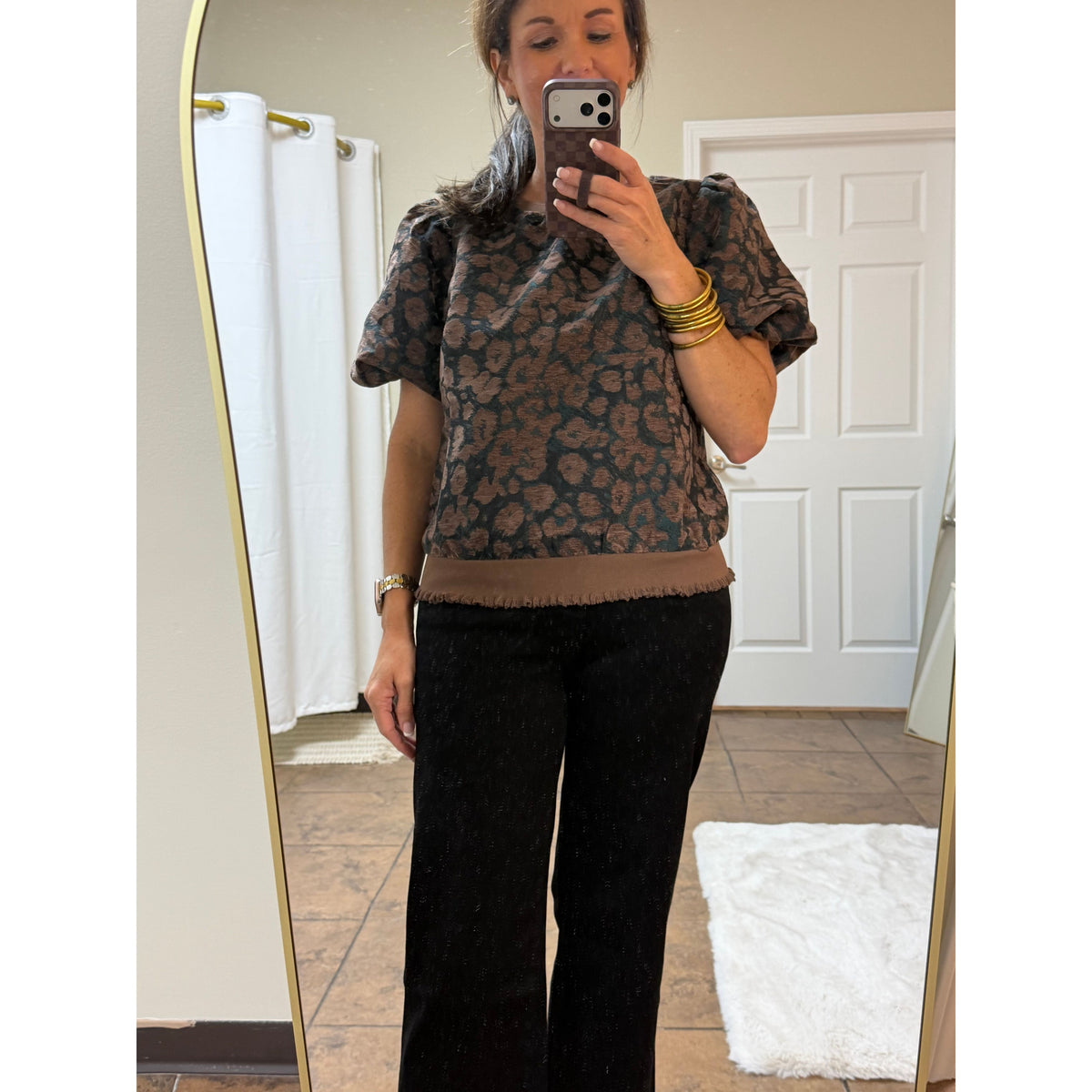 Annie Ks Boutique Black Beauty wide leg cropped jeans paired with a brown leopard print top in a mirror selfie