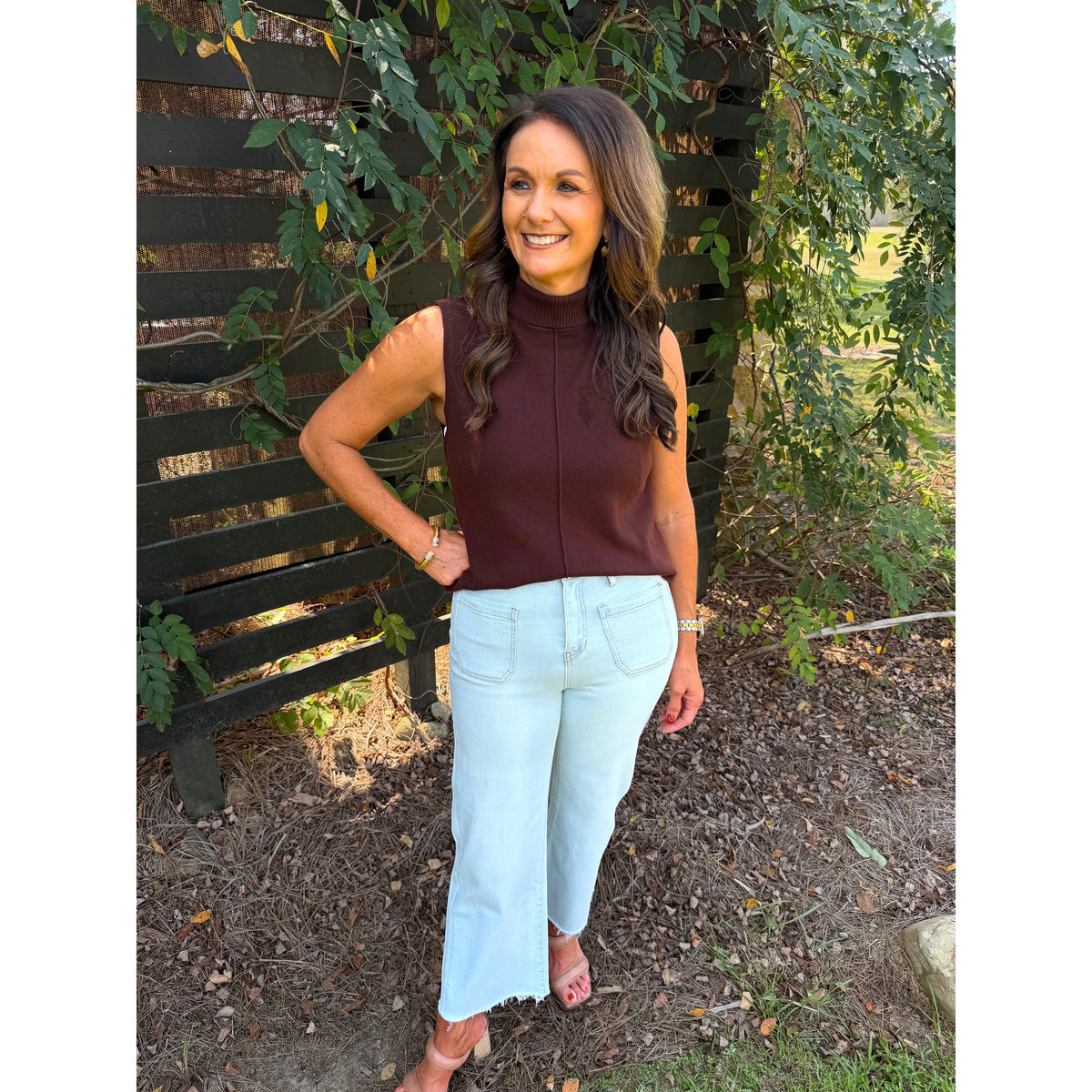 Annie Ks Boutique high-rise wide leg cropped jeans in Blizzard Blue with raw hem, worn with a brown sleeveless top.