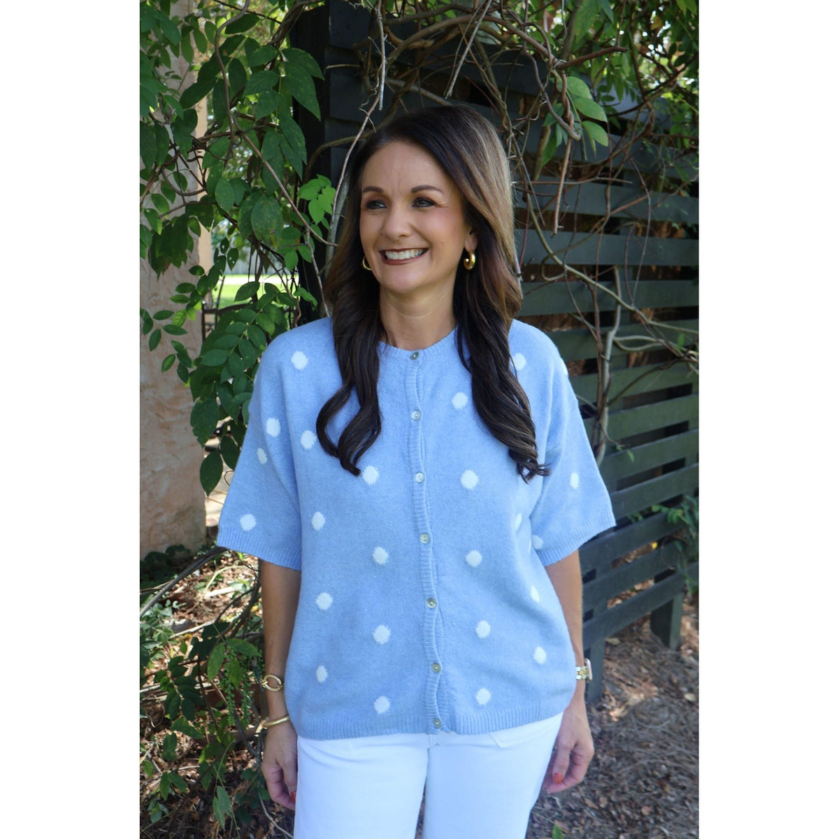Annie Ks Boutique sky blue short-sleeve knit cardigan with white polka dots, crew neckline, and button-front closure.