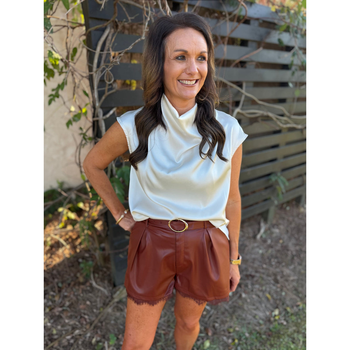 Annie Ks Boutique brick faux leather pleated shorts featuring a delicate lace hem and matching belt with gold buckle