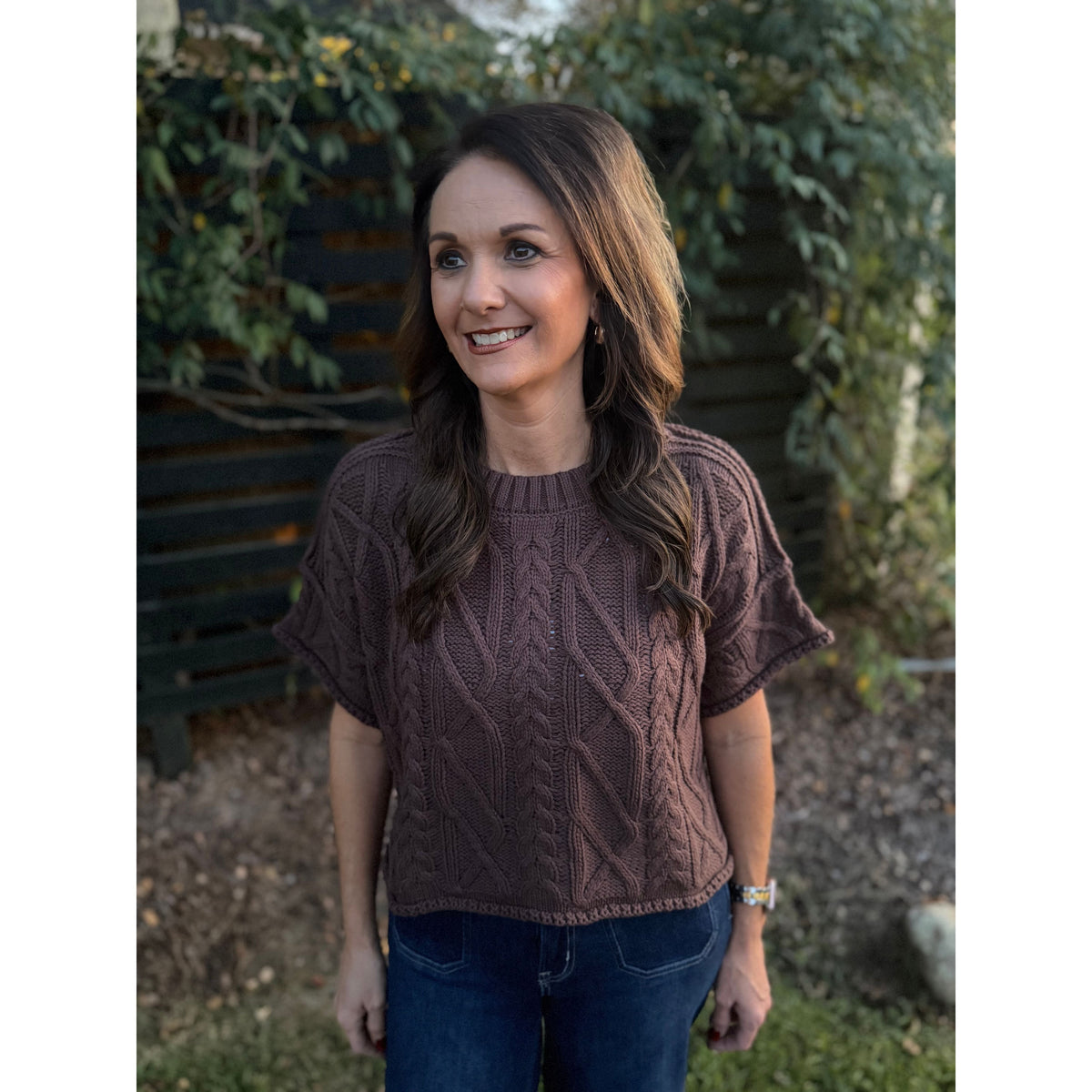 Annie Ks Boutique brown short sleeve cable knit sweater with a round neck and cropped boxy fit worn by a model