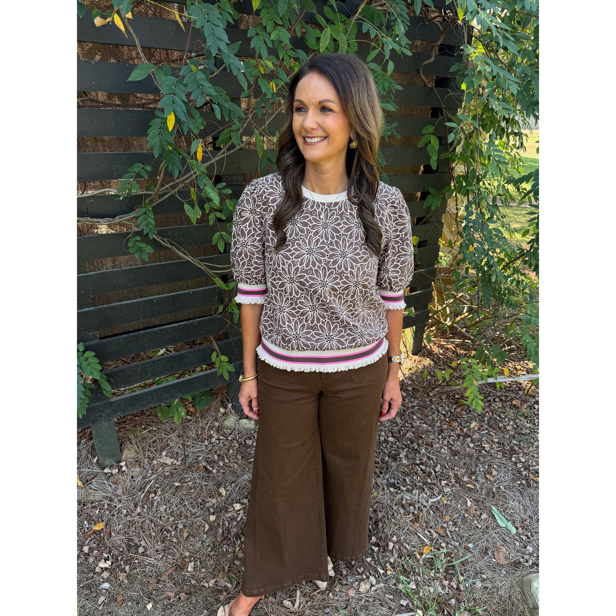 Annie Ks Boutique brown floral eyelet top with puff sleeves and striped ribbed trim worn with brown wide-leg pants