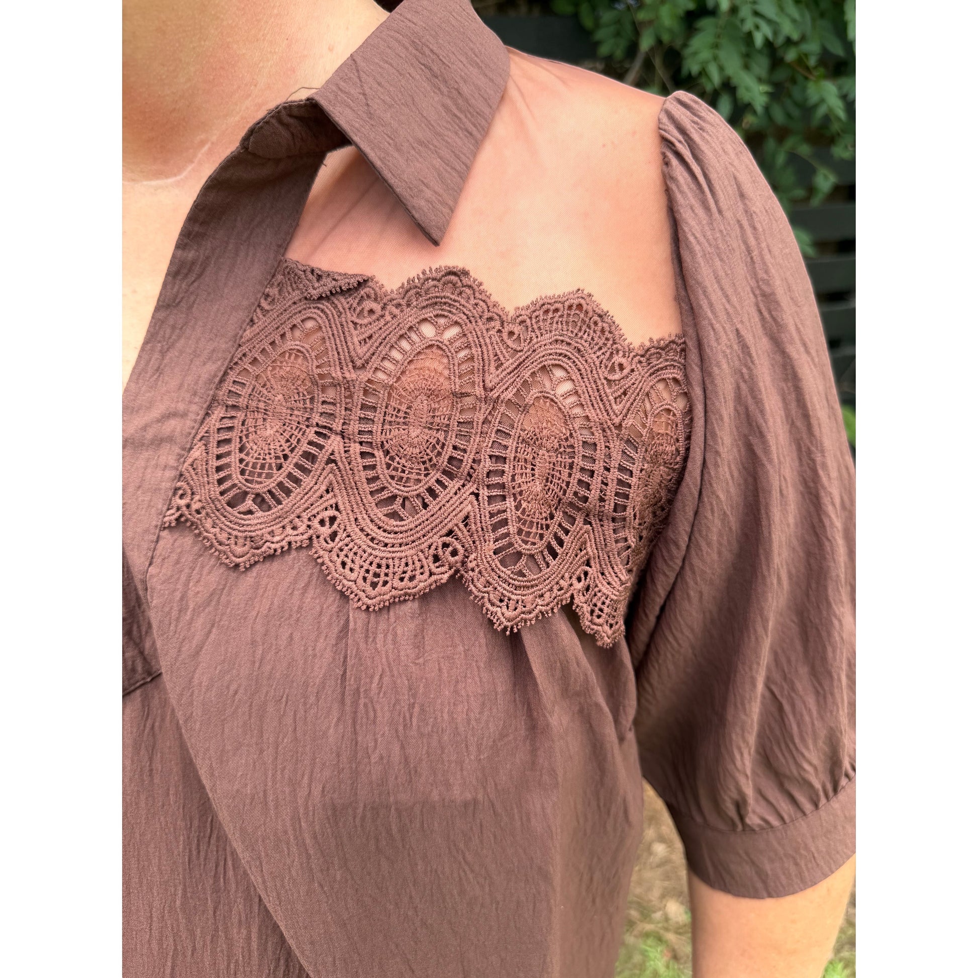 Annie Ks Boutique brown blouse featuring sheer mesh shoulders, delicate lace trim, a collar, and short puff sleeves.