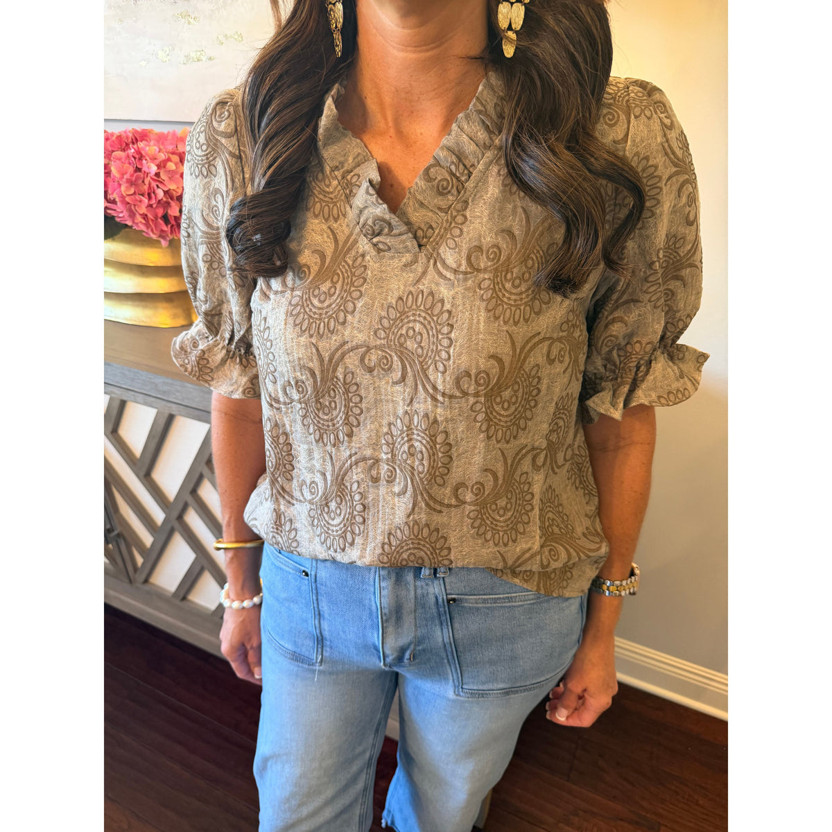 Annie Ks Boutique brown paisley print blouse with ruffle V-neck and puff sleeves worn with light wash jeans