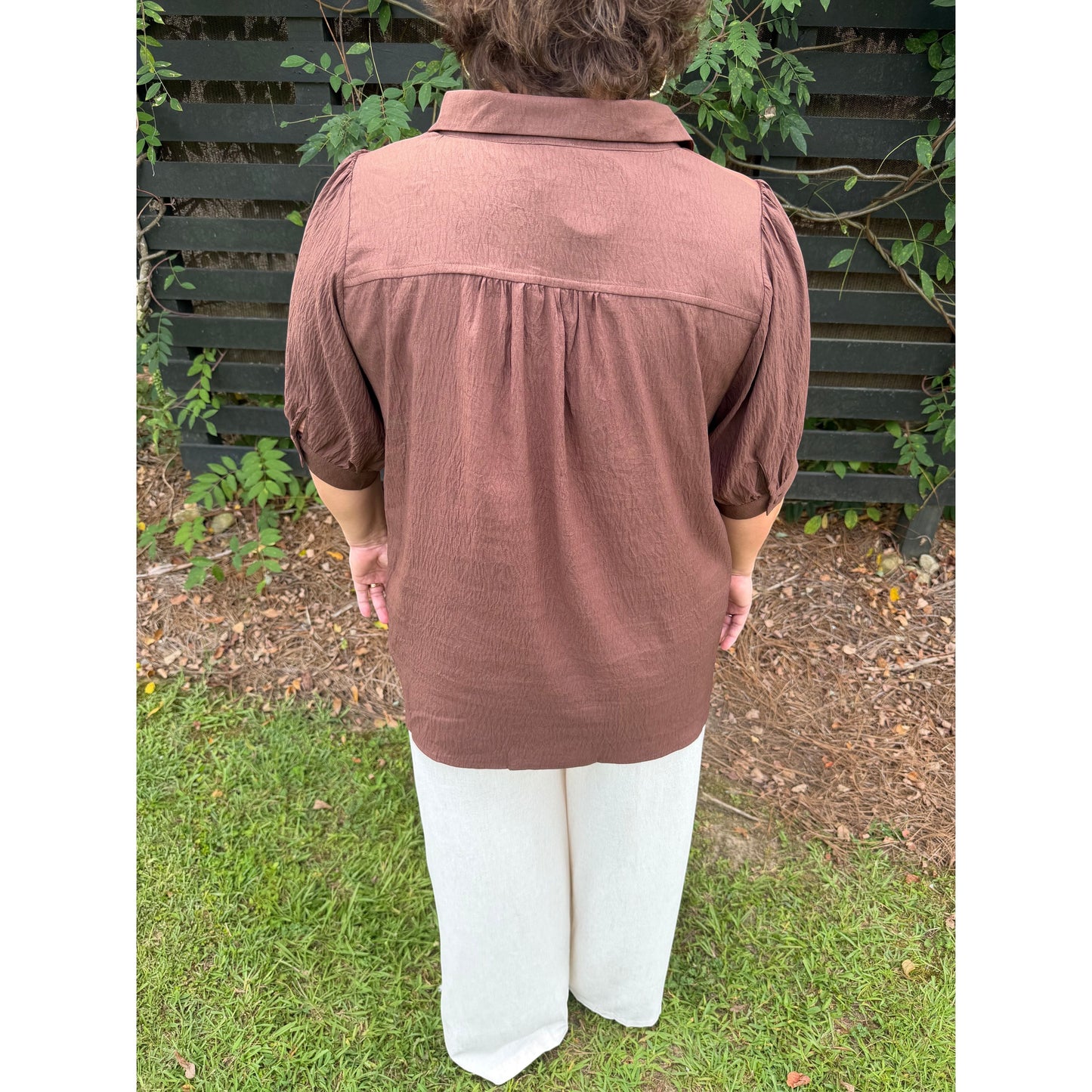 Annie Ks Boutique brown collared blouse with short puff sleeves and gathered back detail worn with white wide leg pants