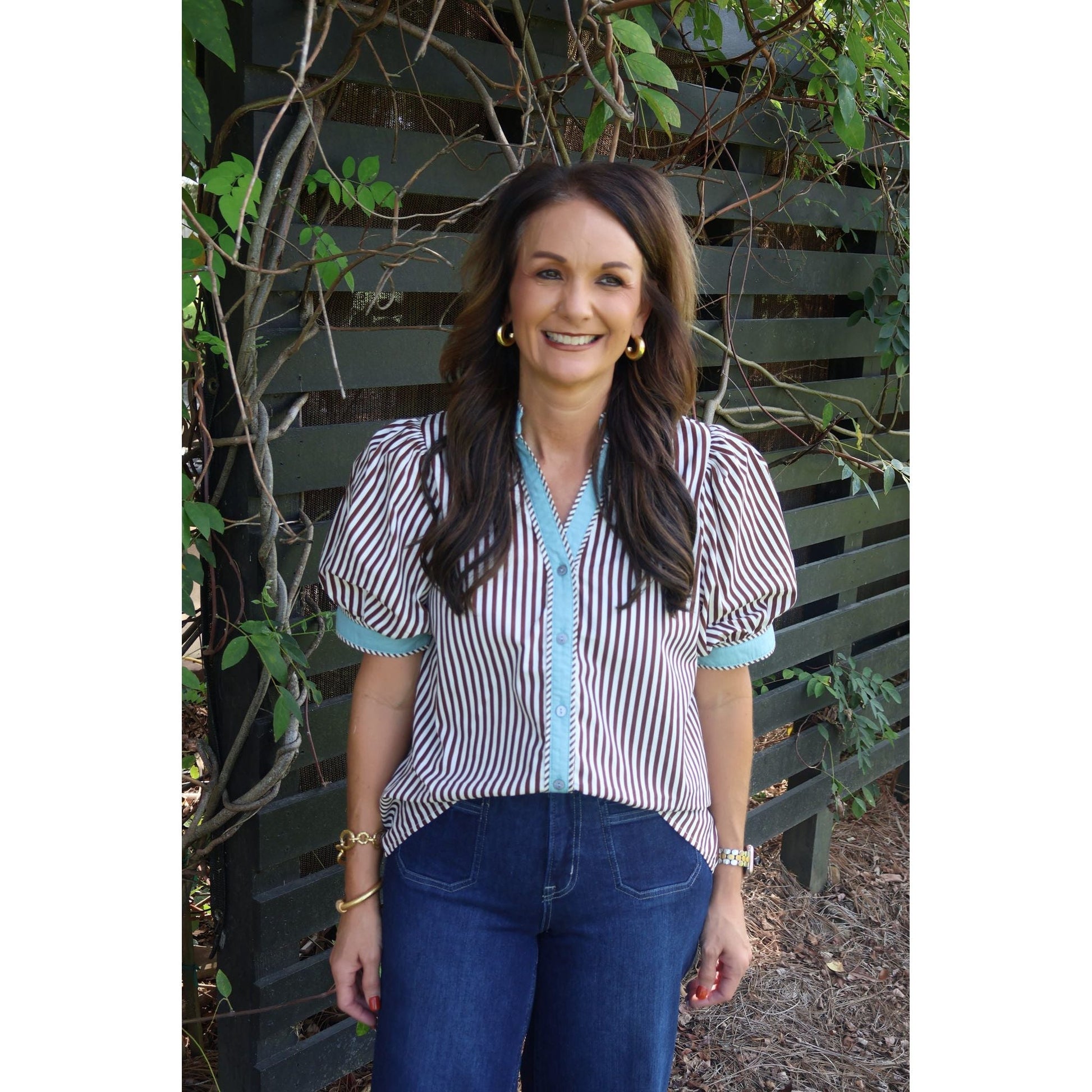 Annie Ks Boutique brown and cream striped cotton top with puff sleeves worn by a woman outdoors.