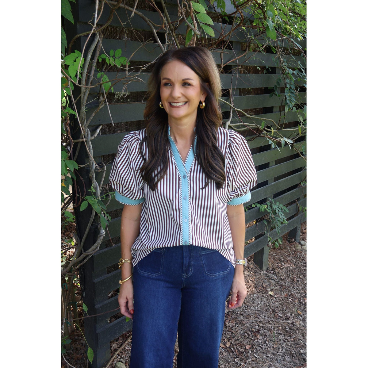Annie Ks Boutique brown and cream striped cotton top with puff sleeves worn by a smiling woman outdoors