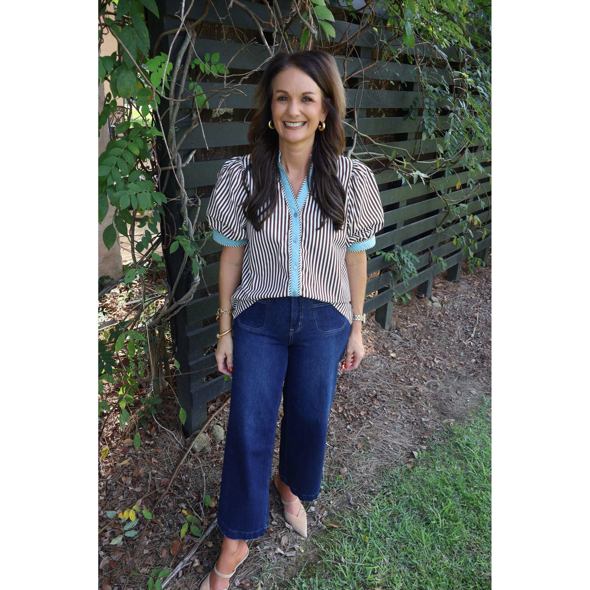 Annie Ks Boutique brown and cream striped cotton top with puff sleeves worn by a woman with dark hair outdoors.