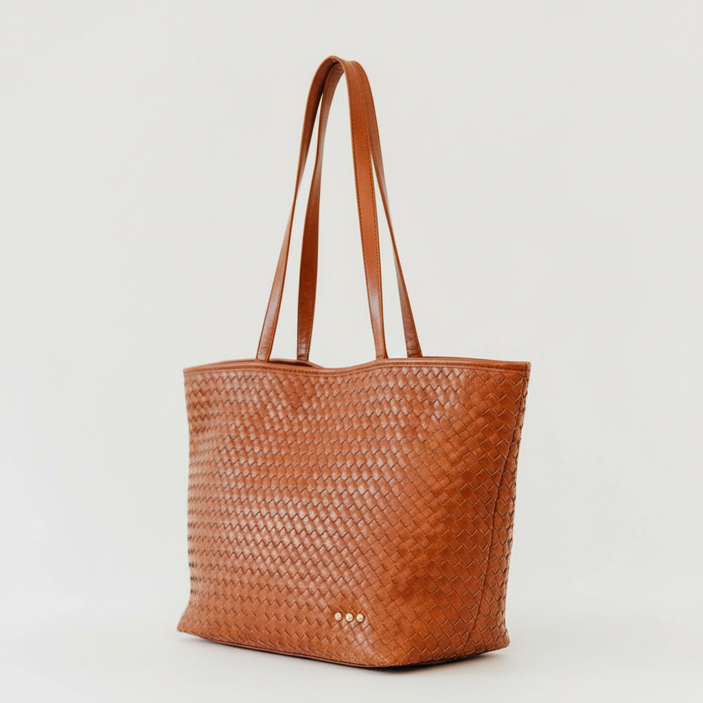 Annie Ks Boutique brown woven vegan leather tote bag with long shoulder straps and a structured design.
