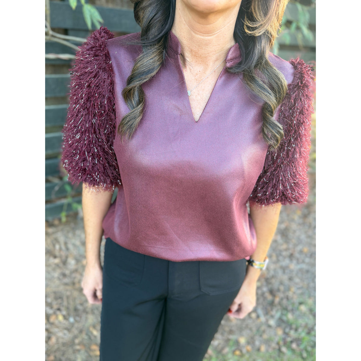 Annie Ks Boutique burgundy faux leather top with short metallic feather fringe sleeves and a split neckline