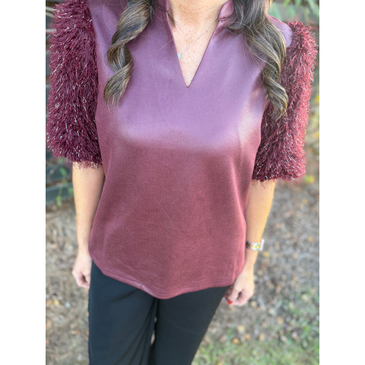 Annie Ks Boutique burgundy faux leather top with short metallic feather fringe sleeves and a split neckline