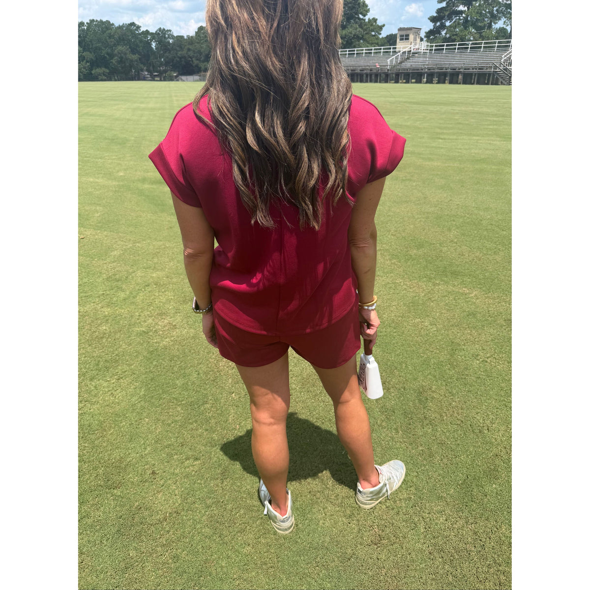 Annie Ks Boutique burgundy scuba modal short-sleeve top and shorts set worn by a woman on a grassy field