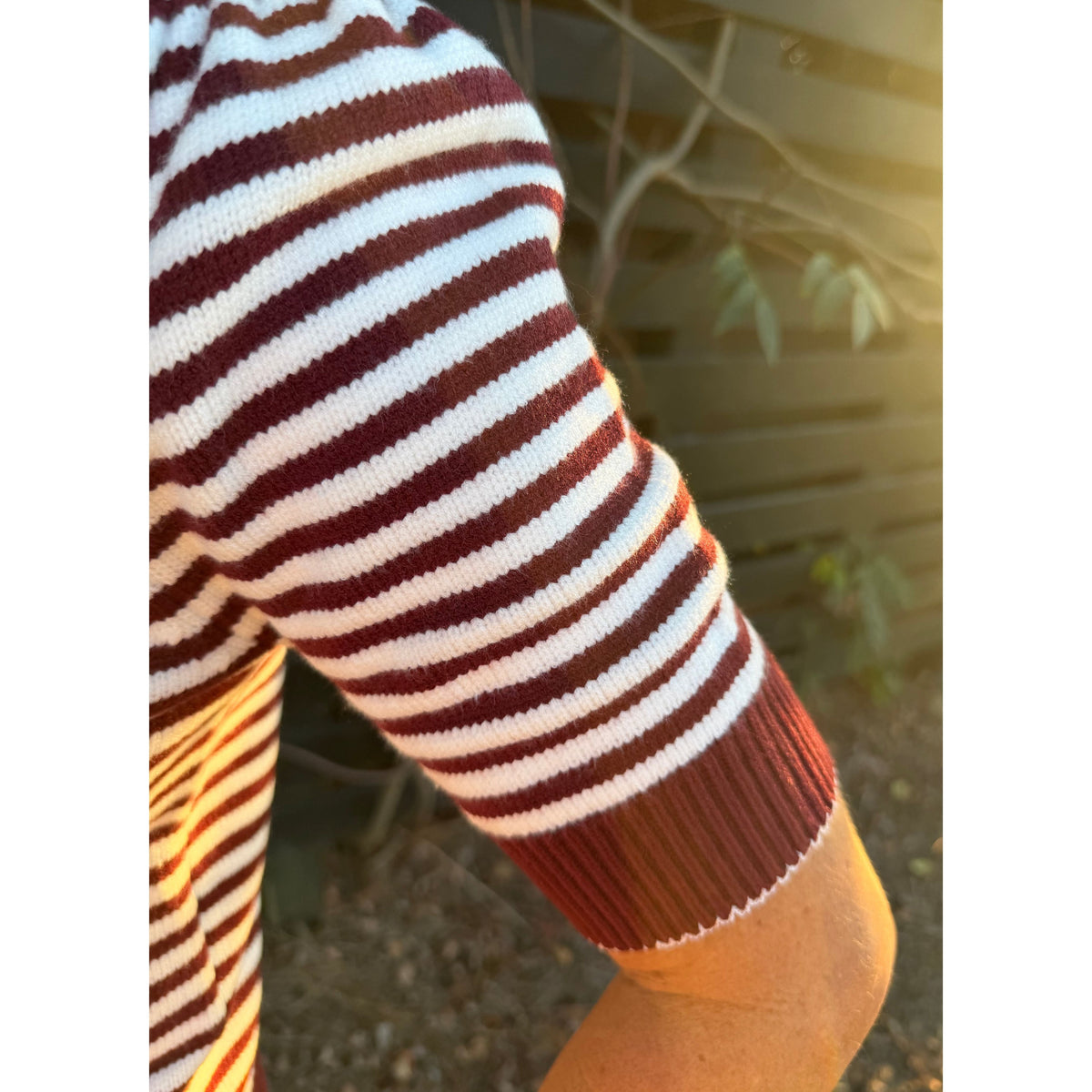 Annie Ks Boutique burgundy and white striped short-sleeve knit cardigan showing sleeve detail in natural light