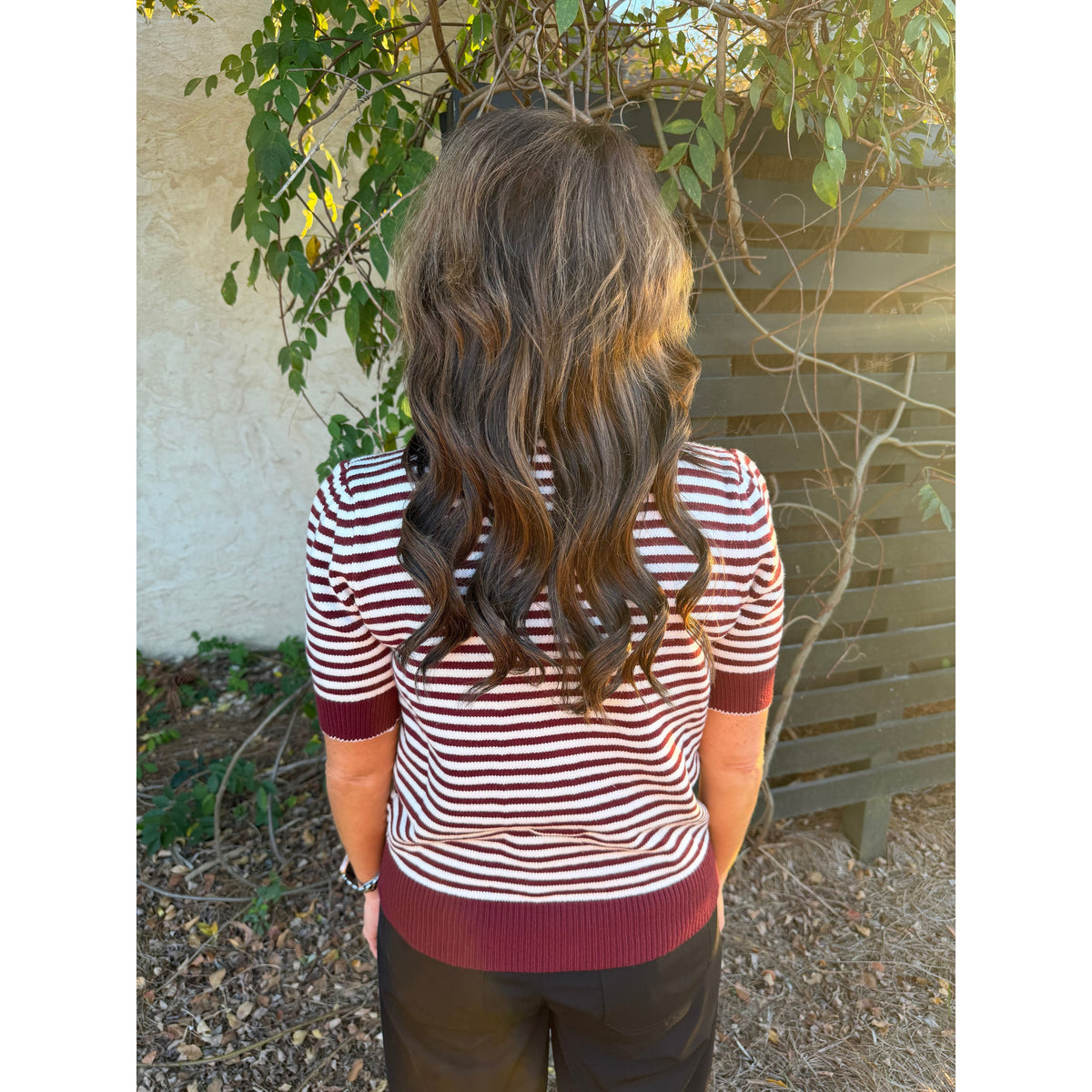 Annie Ks Boutique burgundy and white striped short-sleeve knit top worn by a woman with long wavy brown hair