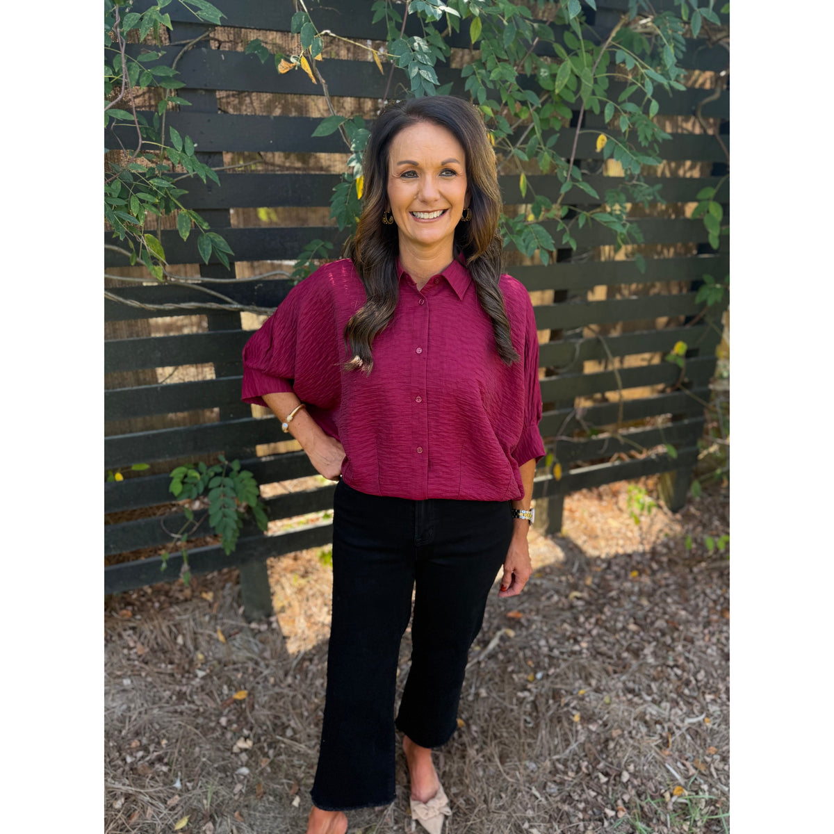 Annie Ks Boutique burgundy textured short sleeve button-front blouse with dolman sleeves worn with black trousers