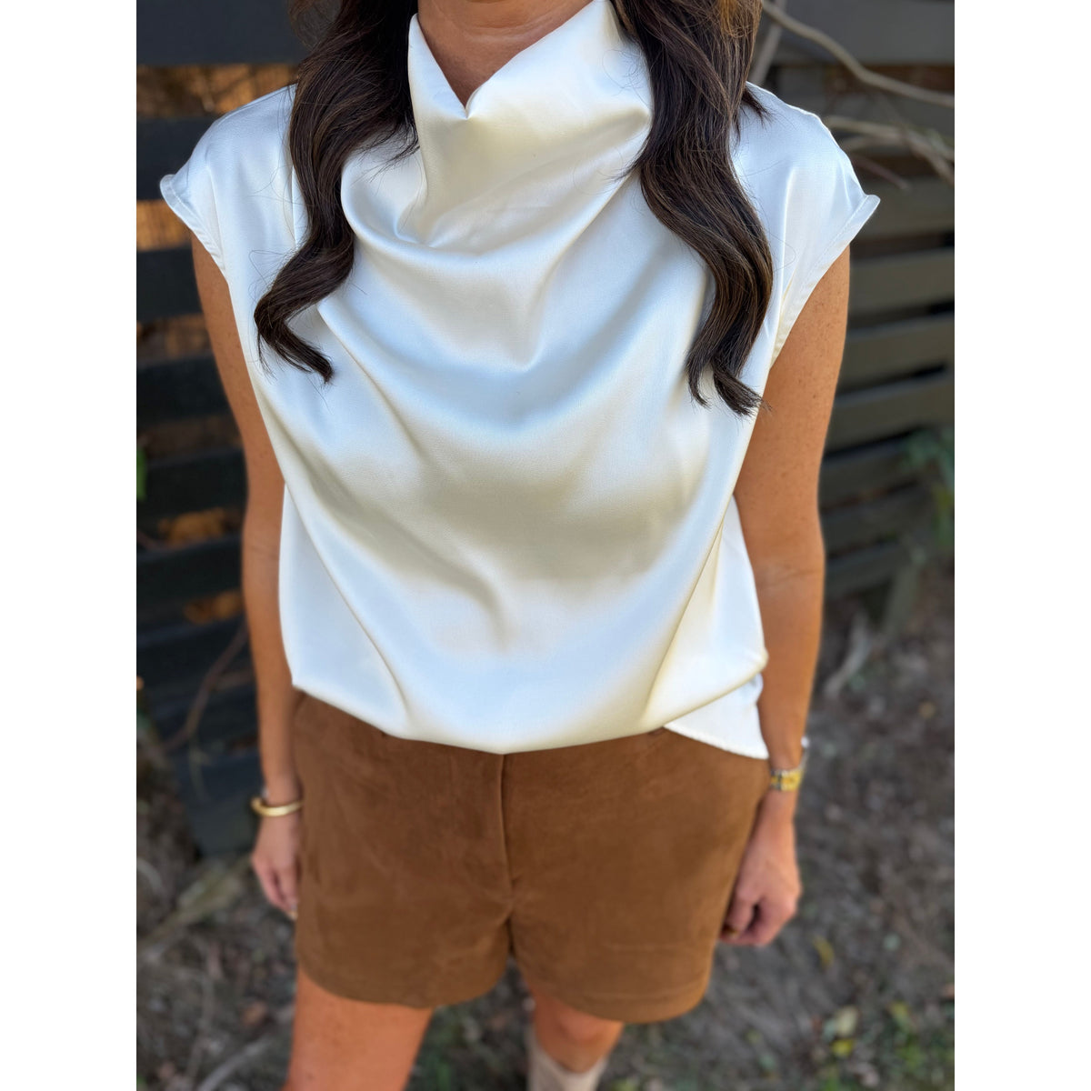Annie Ks Boutique camel brown faux suede shorts paired with a white satin cowl neck top for a stylish autumn look.