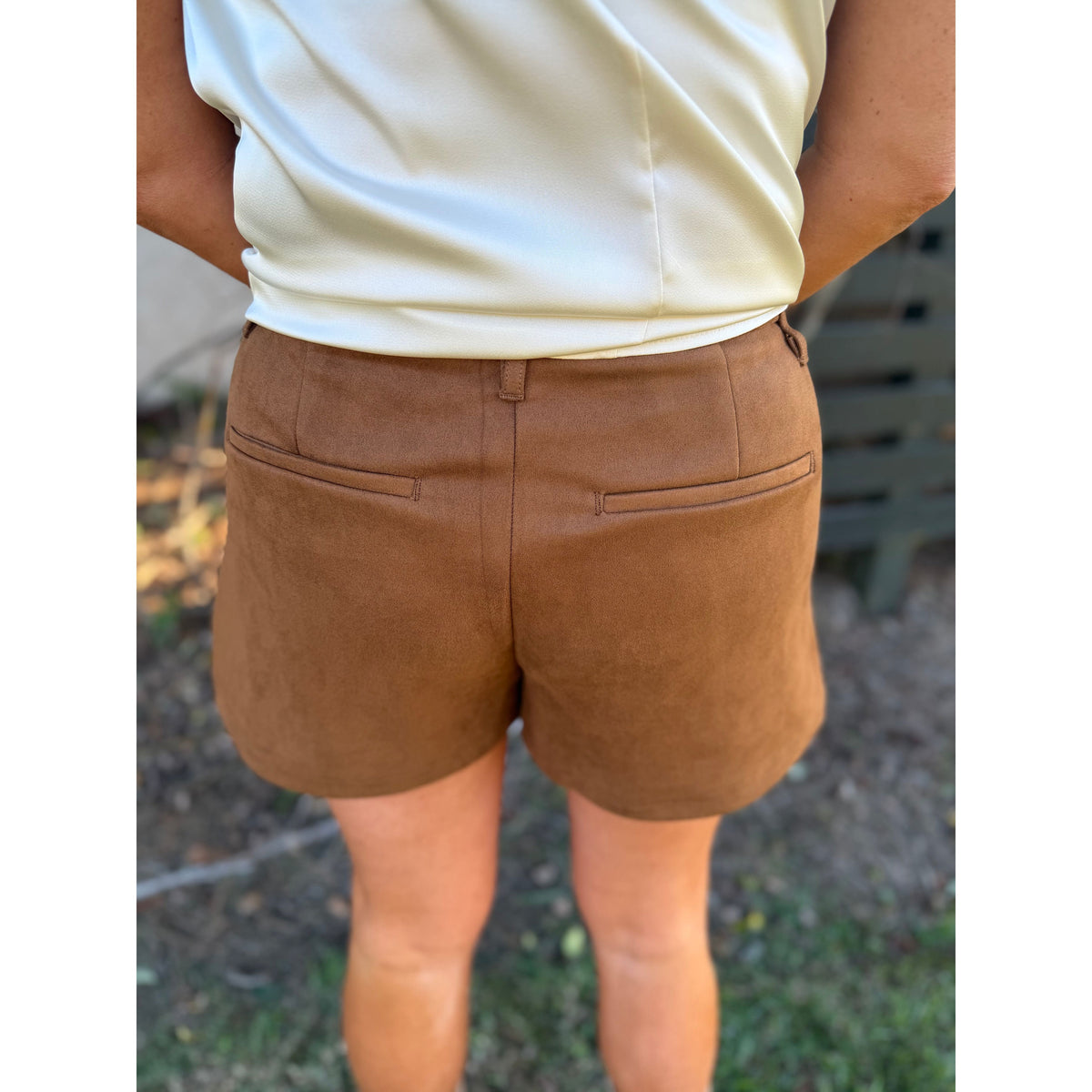 Back view of Annie Ks Boutique camel brown faux suede shorts with functional pockets and a relaxed fit
