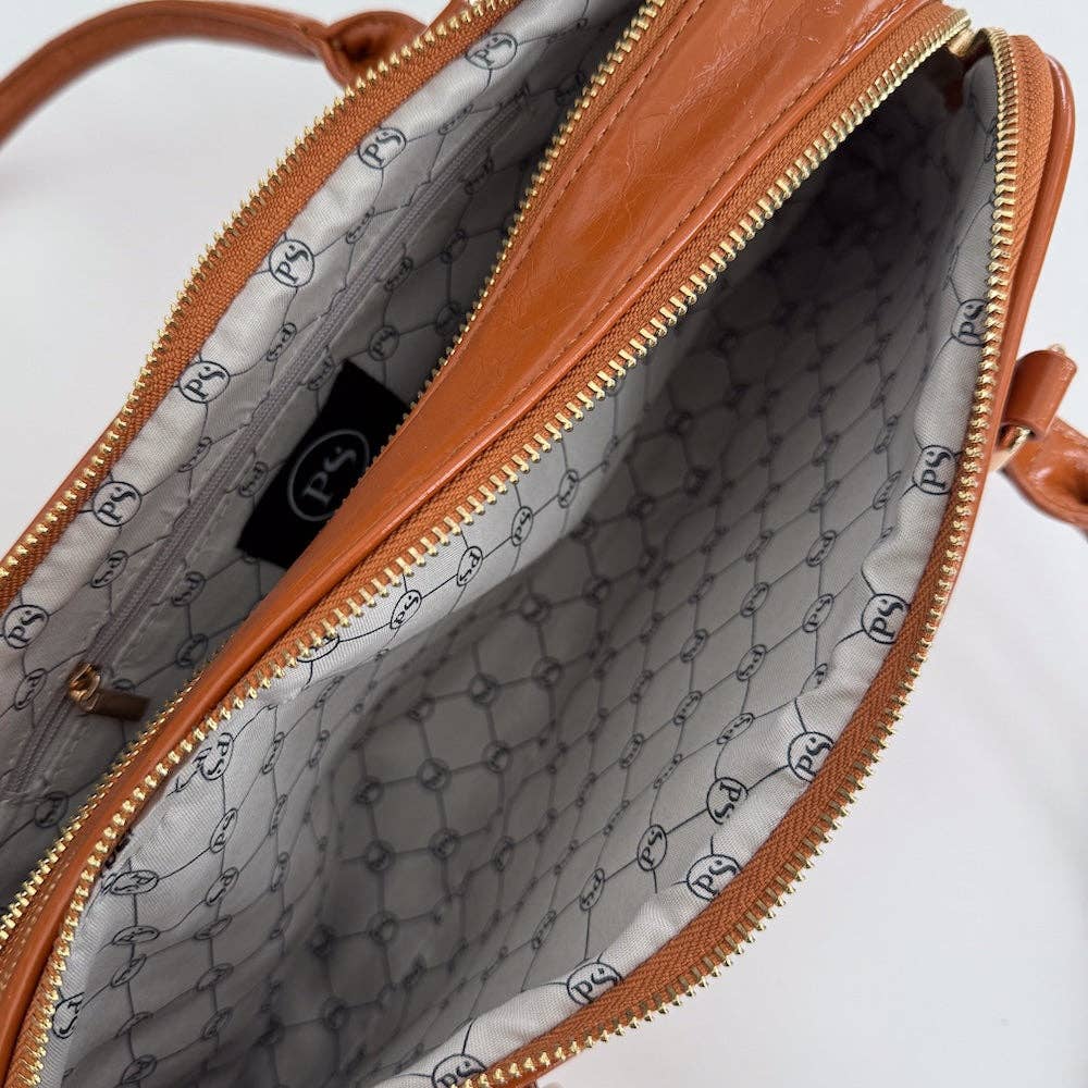 Annie Ks Boutique Arlys barrel shoulder bag in caramel vegan leather showing the interior with branded lining