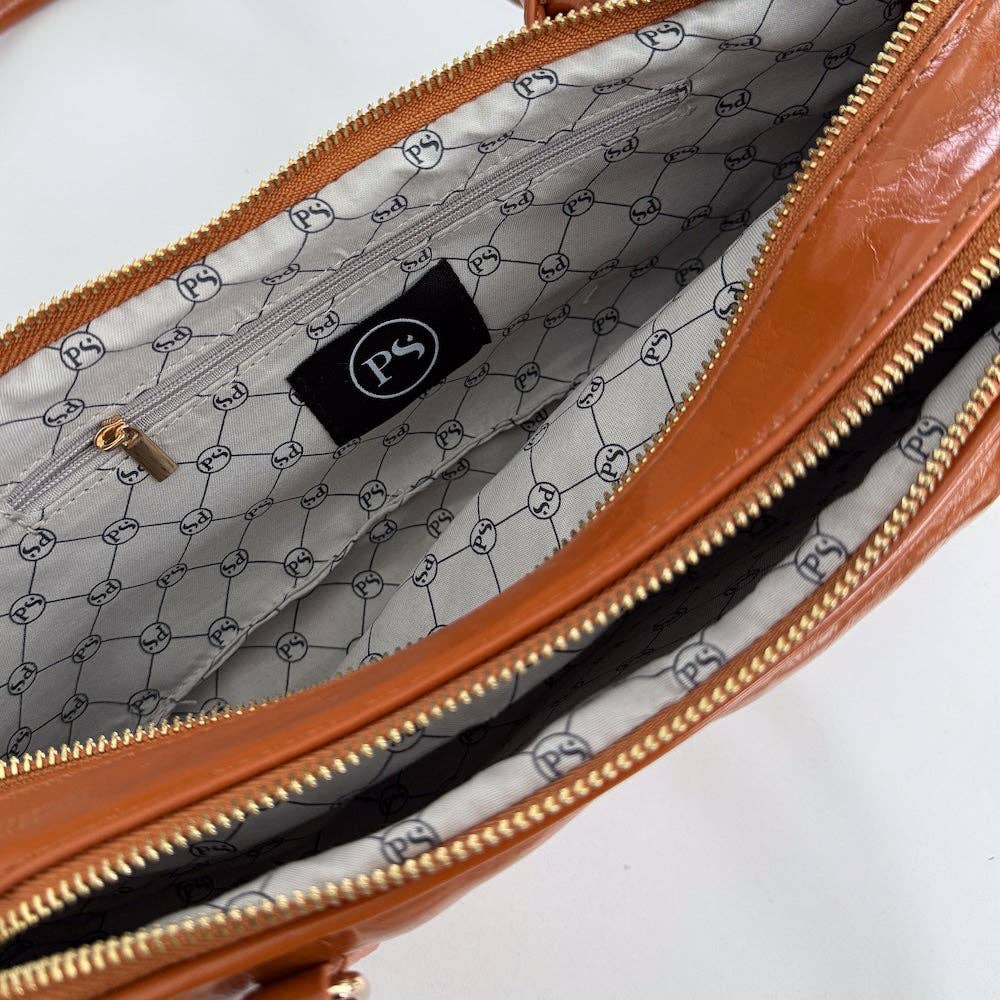 Annie Ks Boutique Arlys barrel shoulder bag in caramel vegan leather showing the interior with branded lining