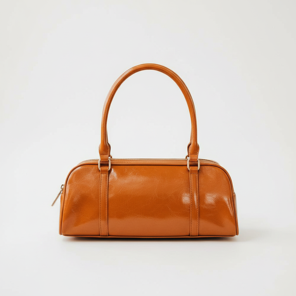 Annie Ks Boutique Arlys barrel shoulder bag in smooth caramel vegan leather with a structured silhouette and top handle