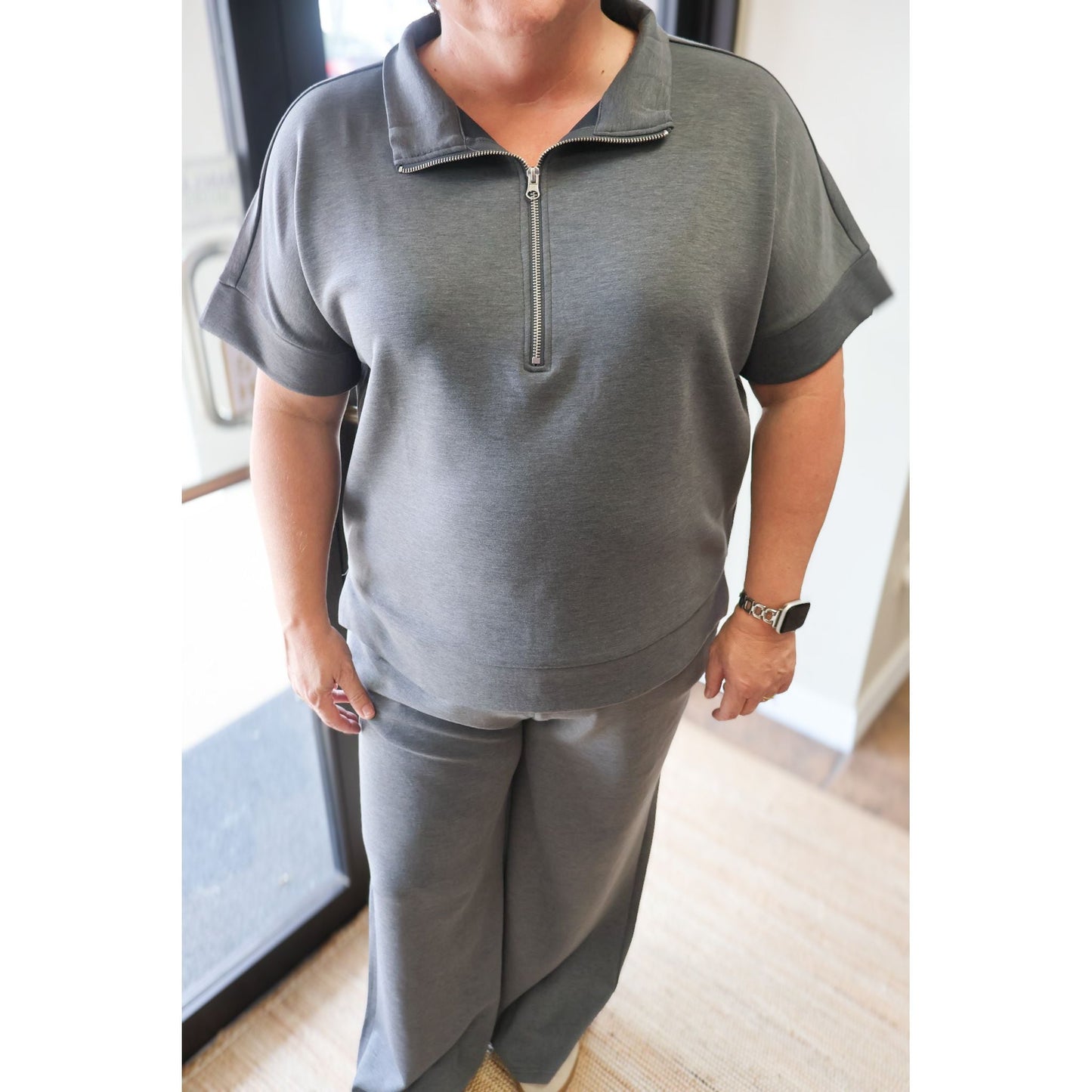 Annie Ks Boutique charcoal scuba knit two-piece set with a short-sleeve half-zip top and matching wide-leg pants.