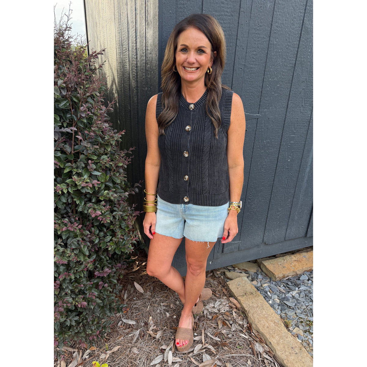 Annie Ks Boutique charcoal knitted cotton sweater vest with button front and mineral wash finish worn with denim shorts