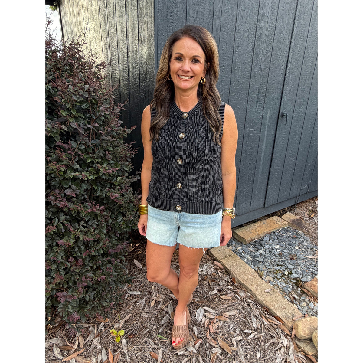 Annie Ks Boutique charcoal mineral-washed cotton sweater vest with button-front detail worn with light denim shorts.