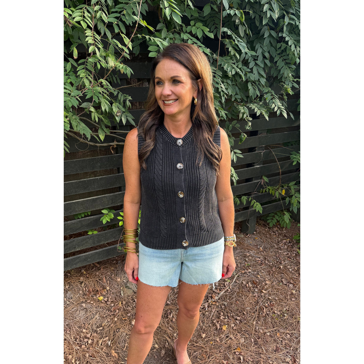 Annie Ks Boutique charcoal cotton sweater vest with button front and mineral wash finish worn by a woman outdoors