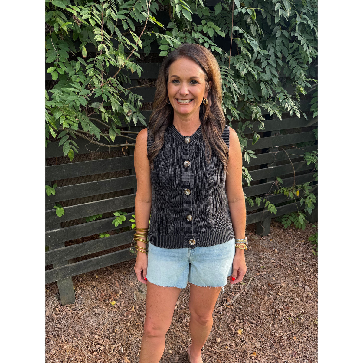 Annie Ks Boutique charcoal mineral-washed cotton sweater vest with button-front detail worn with denim shorts