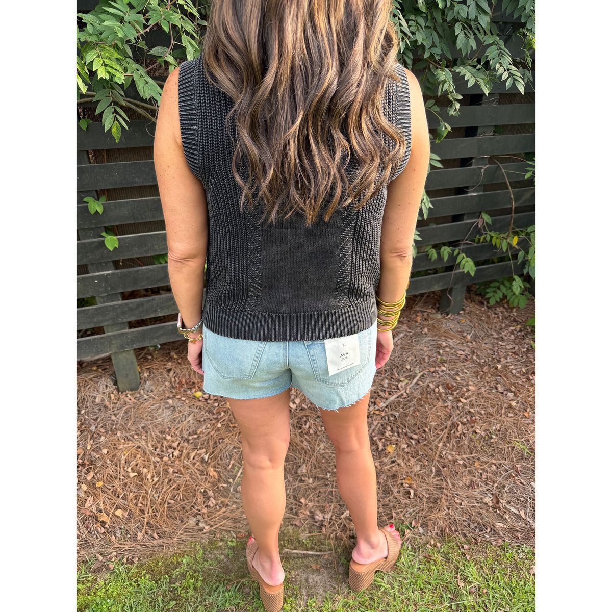 Annie Ks Boutique charcoal mineral-washed cotton sweater vest worn with denim shorts, back view