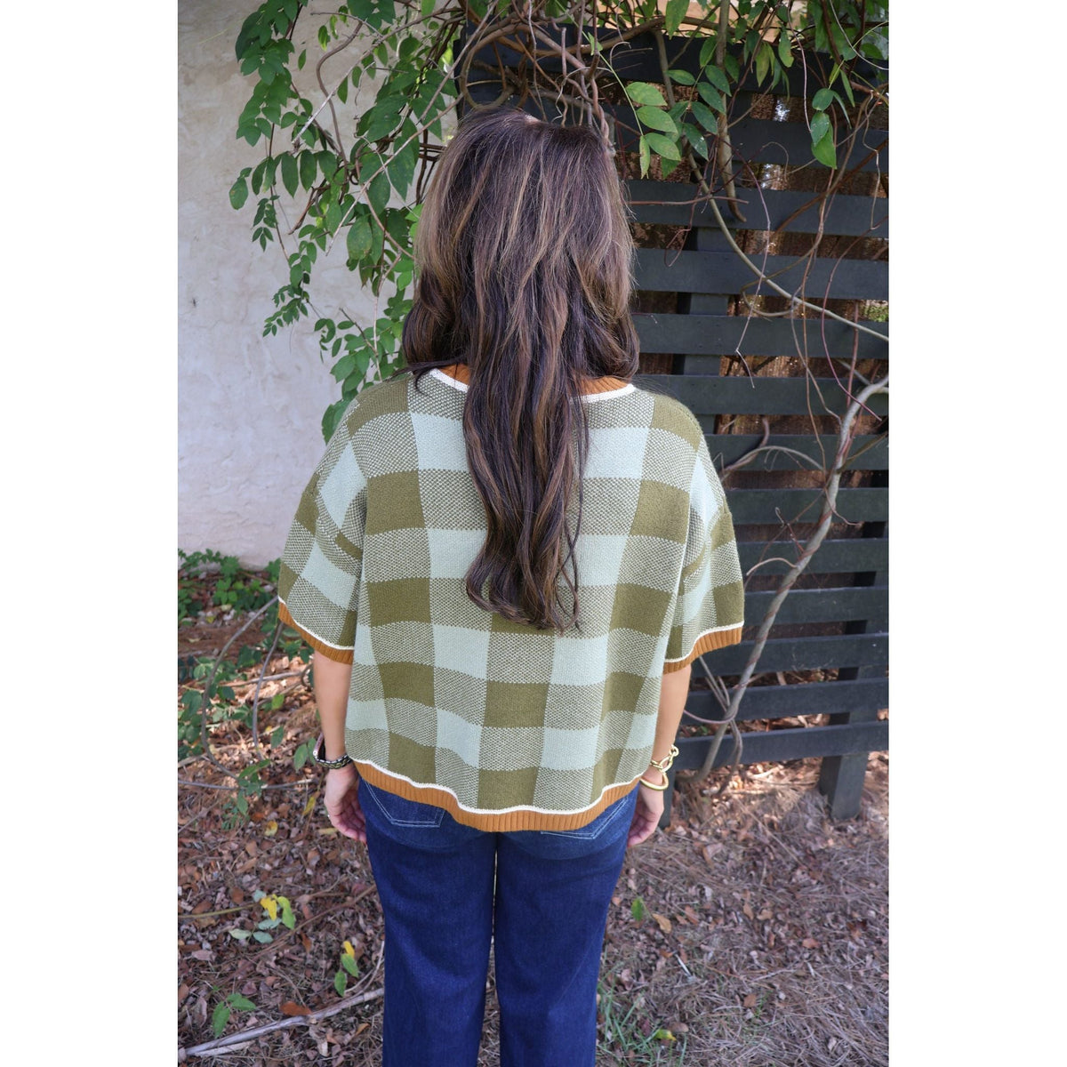 Annie Ks Boutique sage and olive checkered drop shoulder sweater worn with dark wash jeans, back view
