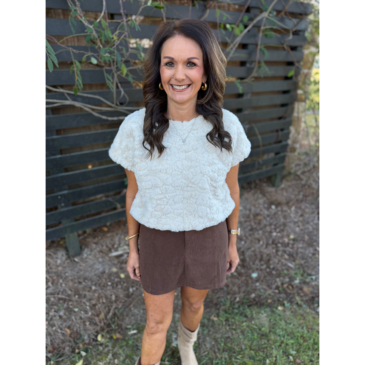 Annie Ks Boutique chocolate brown corduroy mini skirt paired with a white textured short-sleeve top