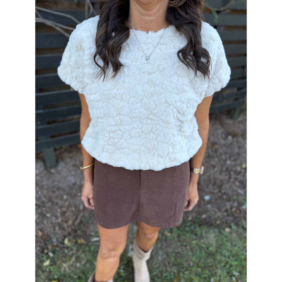 Annie Ks Boutique chocolate brown corduroy mini skirt paired with a white textured short-sleeve top