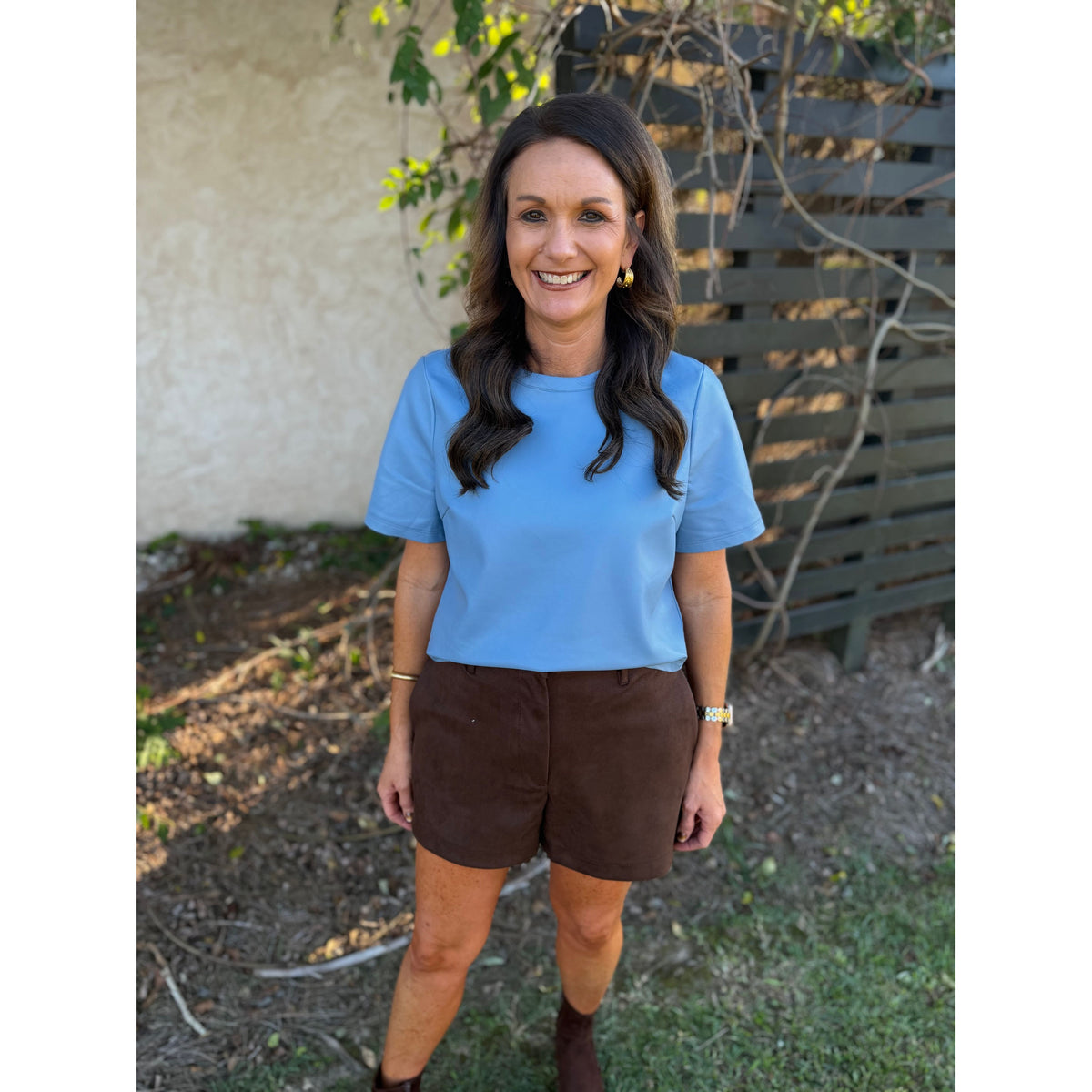Annie Ks Boutique chocolate brown faux suede shorts with a relaxed fit and side pockets worn with a blue t-shirt