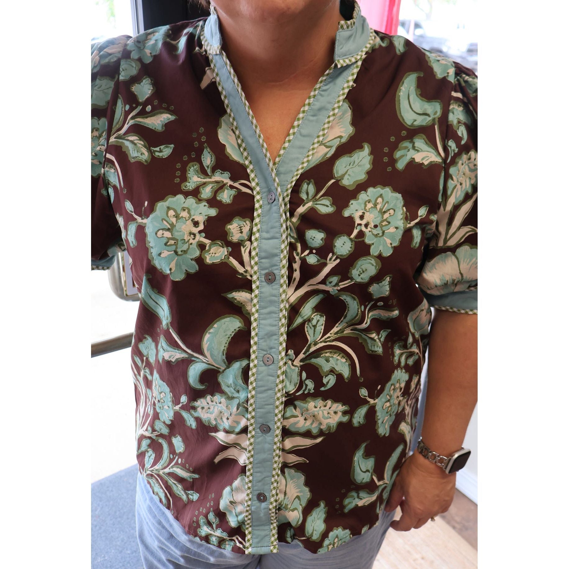 Annie Ks Boutique chocolate brown floral cotton top with short puff sleeves, button front, and contrast trim.