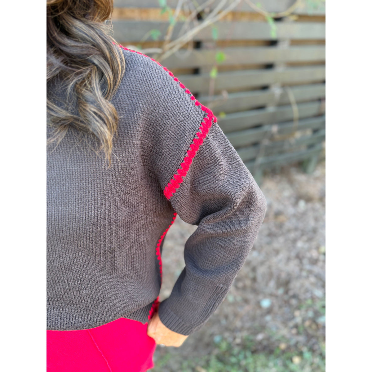 Annie Ks Boutique chocolate brown sweater with contrast red blanket-stitch detailing on the shoulder and sleeve