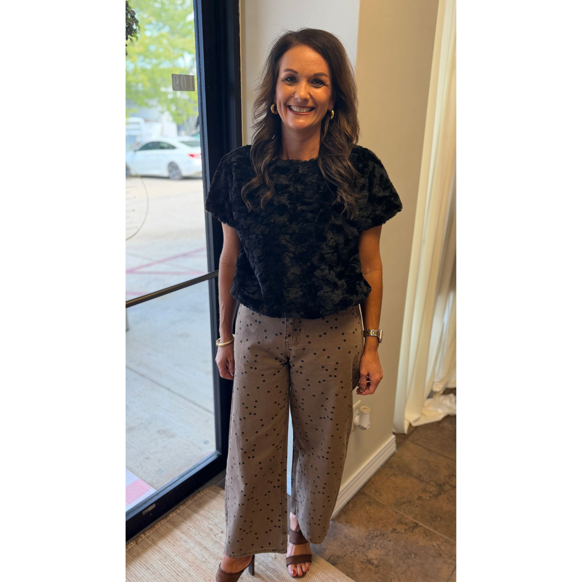 Annie Ks Boutique cocoa barrel pants with black polka dots, styled with a black textured top and brown heels.