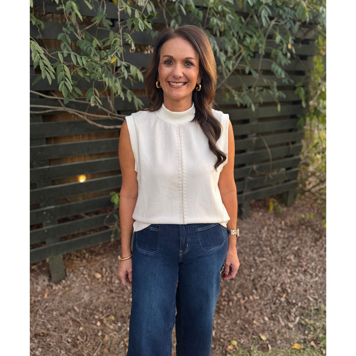 Annie Ks Boutique THML cream sleeveless suede top with delicate accent stitching worn by a smiling woman outdoors.